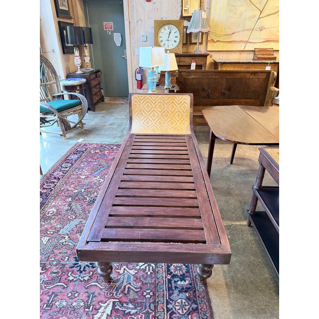A striking antique Colonial chaise longue with the relaxed, sculptural character associated with turn-of-the-century...
