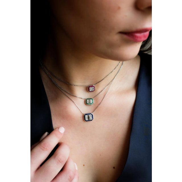 This elegant pendant necklace features a dazzling 0.40 carats of diamonds set in a striking geometric pattern at the...