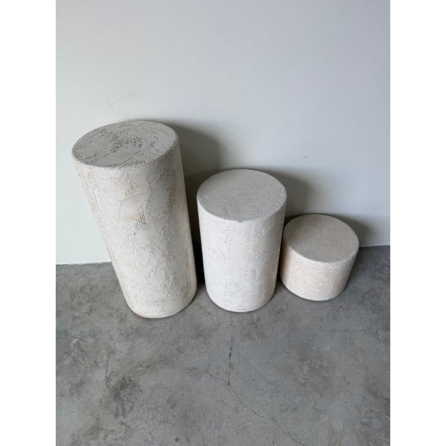 Striking Vintage Postmodern Set of 3 Pedestals, each crafted from wood and finished with a textured plaster surface....