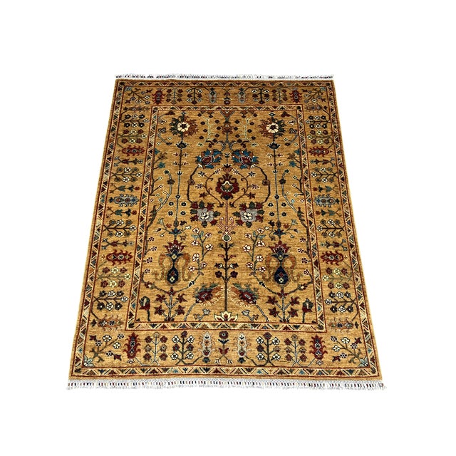 This Sultani wool rug features a Persian style botanical design of flowering vines, branching stems and ornamental...