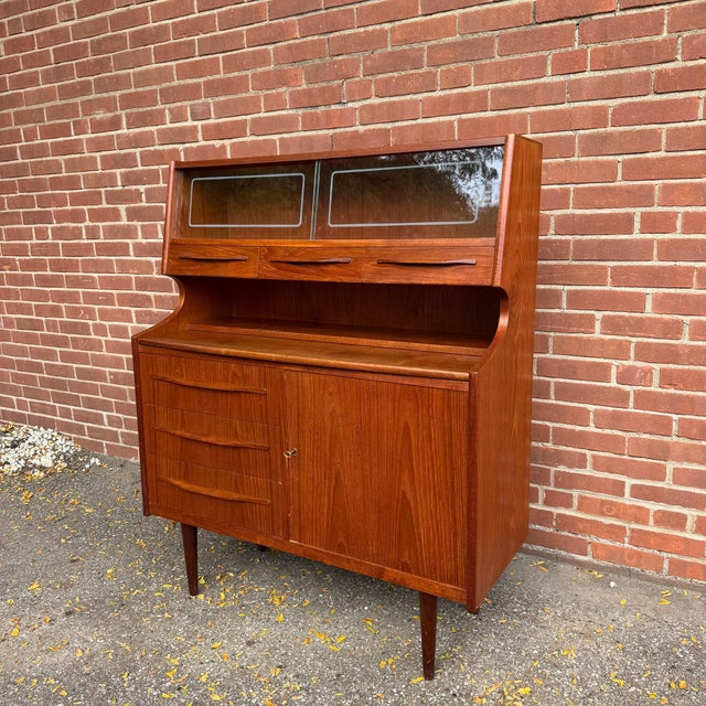 Danish Modern teak secretary desk and hutch by N.P. Nielsen for Sejling Skabe, produced in Denmark circa the 1960s. The...