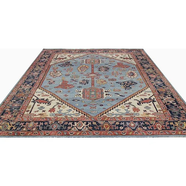 Traditional Handwoven Serapi Style Area Rug featuring a medallion and corner design in a light blue-colored field enclosed...