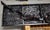Black and red artillery artography wall sculpture featuring repurposed fragments of shotguns, rifles, and gun barrels by...