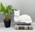 Charming ceramic cat figurine made in Holland, featuring a glossy white glaze and a relaxed reclining pose with its tail...