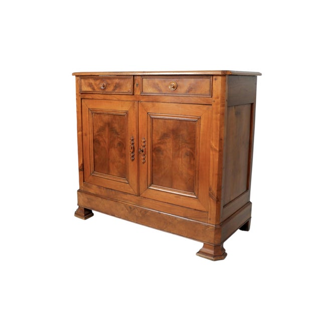 A Louis Philippe period buffet handcrafted in walnut. Two hand dovetailed drawers over cabinet doors are decorated with...