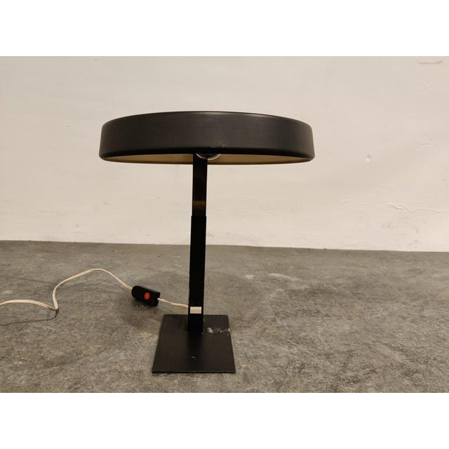 Rare green metal and brass desk lamp designed by Louis Kalff for Philips. The lamp is in a good original condition with...