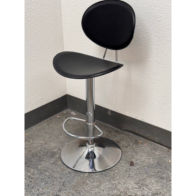 Design Plus Gallery presents a Contemporary Faux Leather Adjustable Swivel Stool. The curved leather seat and rounded...