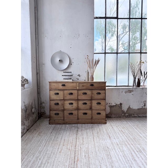 A vintage pine workshop cabinet from the 1950s, featuring numerous drawers. we love its compact size and ample storage...