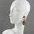 Cilea Paris designed these elegant clip-on earrings. These dimensionally dangling artisanal resin earrings feature a...