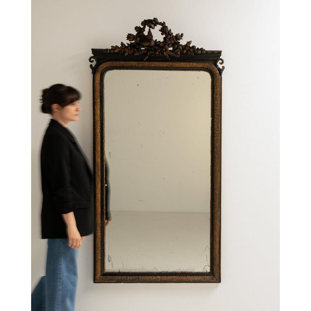This piece presents as a mirror, distinguished by dark bronze ornate carved frame, tall. Dating to 19th Century and...