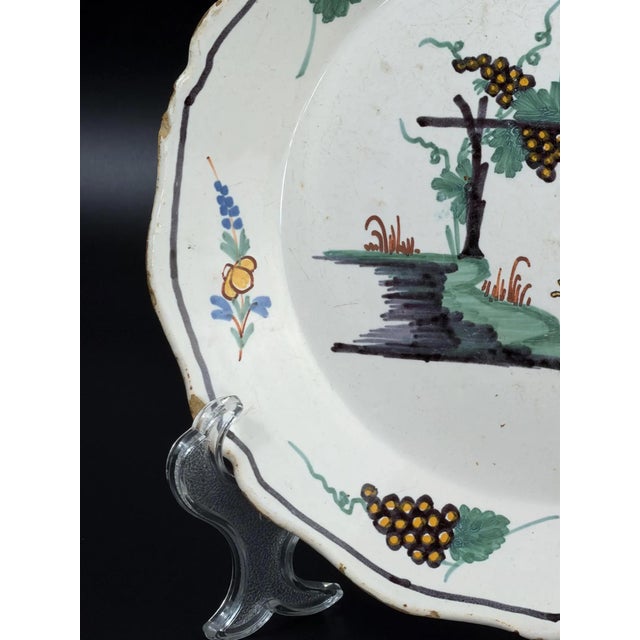 Authentic French faience plate from the Nevers region, dating to the second half of the 18th century. The plate features a...