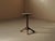 19th-century folk table in solid oak, with a thick, rounded top resting on a simple tripod base. The central column is...