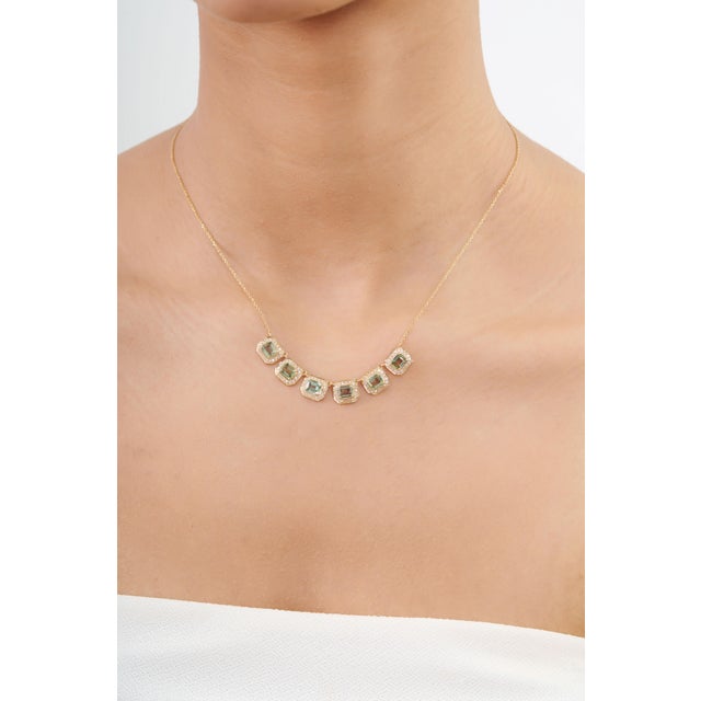 This elegant station necklace features 2.98 carats of green sapphire, set in 14K yellow gold. Each sapphire measures...