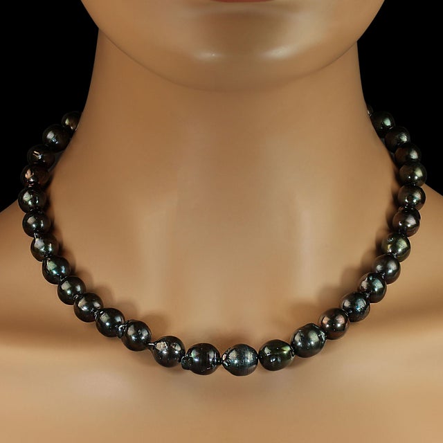 An 18‑inch green and black iridescent pearl necklace already has a striking presence, and expanding the description gives...