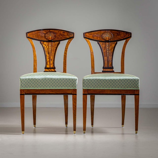 Elegant pair of Viennese chairs, the outstanding quality of the Empire chairs can be seen in the design of the backrest...