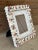 Beautiful handmade seashell picture frame adorned with pops of color and natural seashells. Frame can hold a 5x7 with mat...