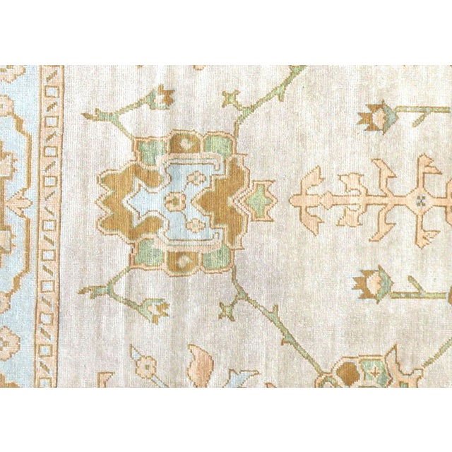 This Vintage Turkish Oushak Rug is a handwoven masterpiece from Western Turkey, measuring 11' x 15'5". Oushak has been...