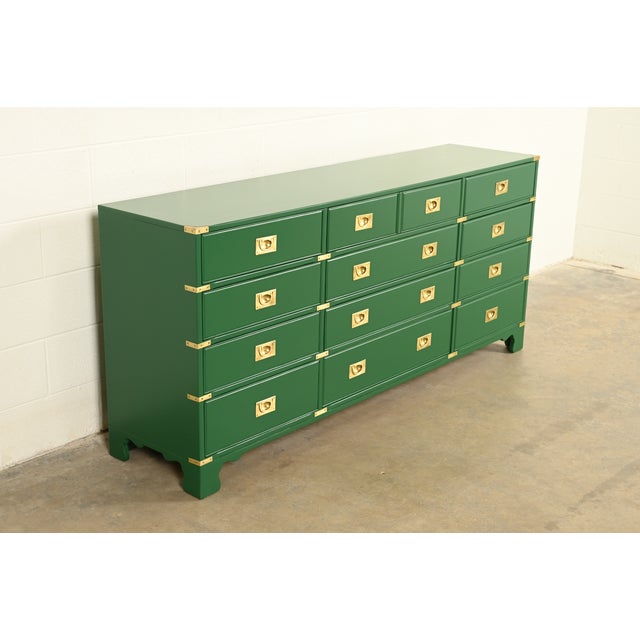 An exceptional mid-century modern Hollywood Regency Campaign twelve-drawer dresser, credenza, or chest of drawers By...