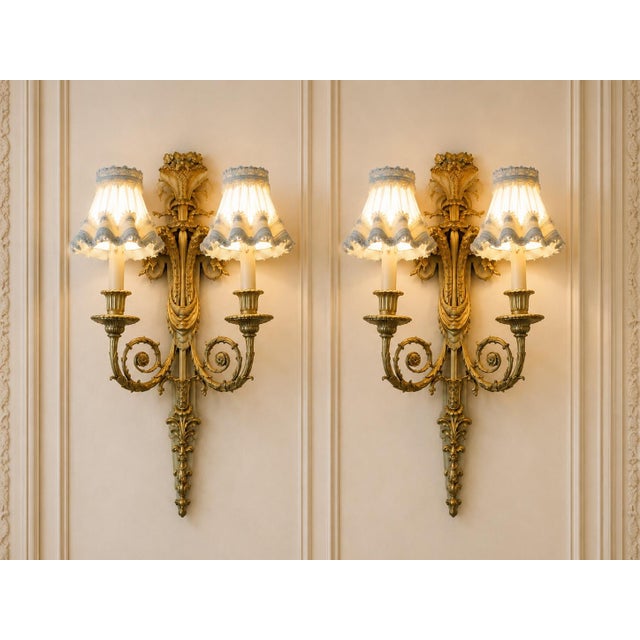 This exceptional pair of circa 1860 French Louis XVI wall sconces combines finely cast bronze, original fire-gilt ormolu...