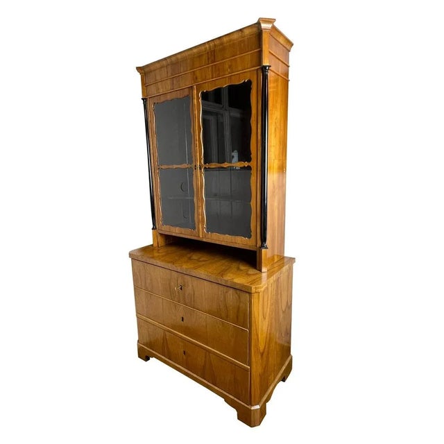 Original showcase (No. 1474) Type of wood: cherry oak Color: nature Dimensions: Height: 209 cm Width: 106 cm Depth: 52 cm...