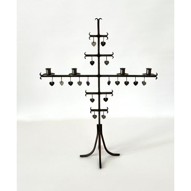 1960s hand wrought steel cross shaped candelabra by Gunnar Ander. Stamped steel hearts are suspended from horizontal arms....