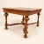 A William and Mary style coffee table with more presence than its size suggests. Four bold inverted-cup legs sit on bun...