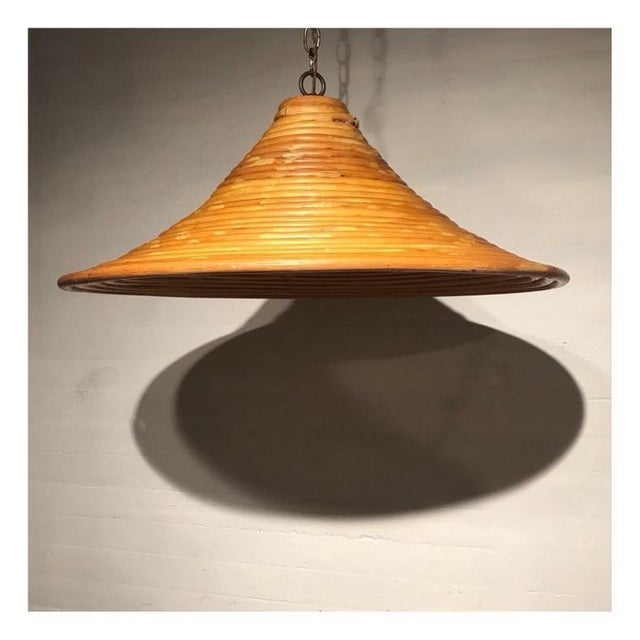 Vintage hanging beehive rattan pendant. Rewired on a long black chain. Plugs into an outlet.