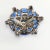 Richly colored vintage brooch comprised of rhinestones in several shades of blue. The iridescent stones are foiled for...