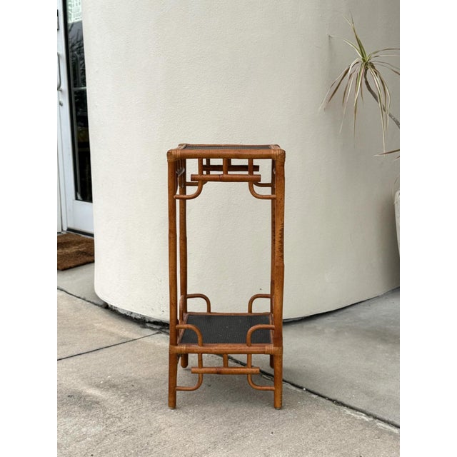 This vintage bamboo planter stand is a stylish blend of Chinese Chippendale, chinoiserie, and Hollywood Regency design in...
