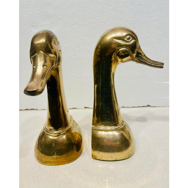 This striking pair of large vintage brass duck head bookends will add character to any bookshelf. Standing an impressive 9...