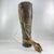 Handcrafted cylindrical drum featuring a stretched hide head, vertical rawhide tensioning, and a wrapped central grip....