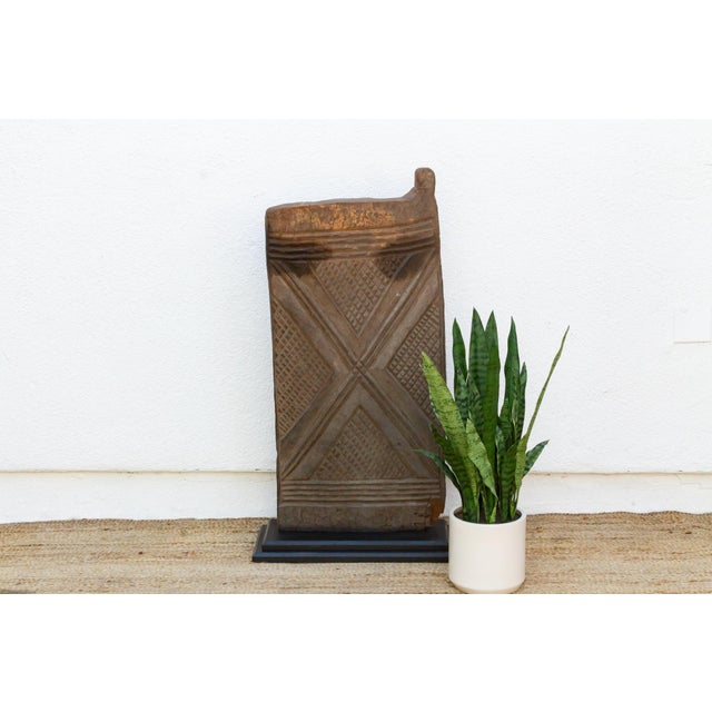 From the Voltaic-speaking regions of southern Burkina Faso, this single-plank door is carved with a bold X motif set...