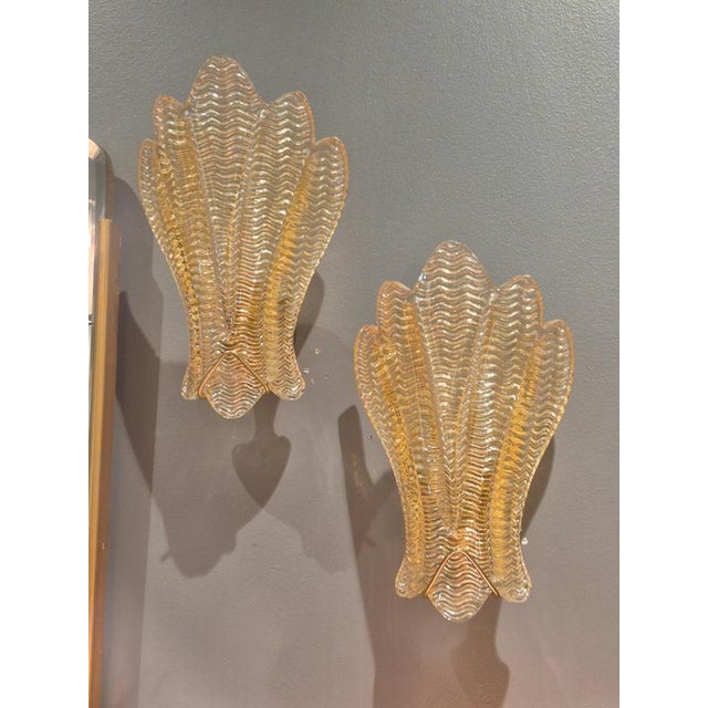 A pair of rare swedish modern sculptural wall sconces model 1715, in goldcolored glass by carl fagerlund, for lyfa, sweden...