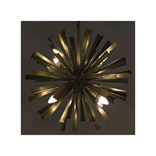 A sculptural spectacle, this bold chandelier inspired by the mid-century starburst motif, takes the look to the next level...