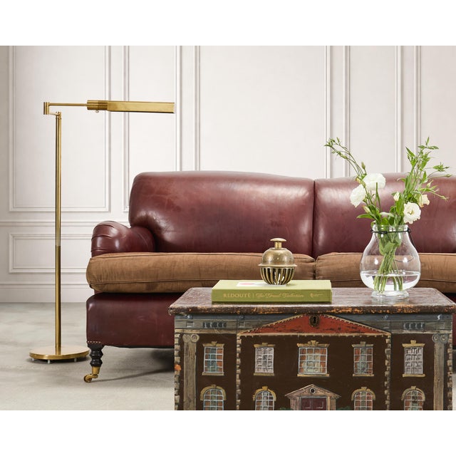 A stylish labeled mid-century modern brass pharmacy task floor lamp made by Casella Lighting, California. The "C1230" lamp...