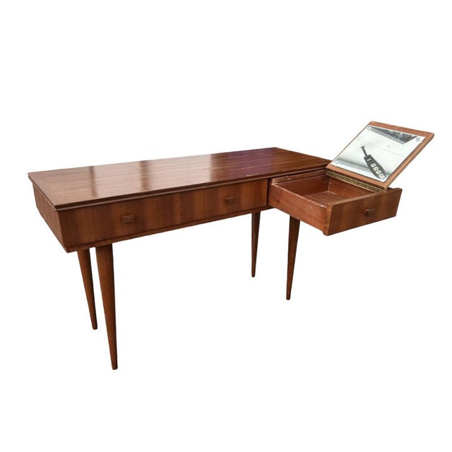 A 1950s teak console table, designed by Gaston Poisson. It features an elegant and clean design, resting on tapered legs...