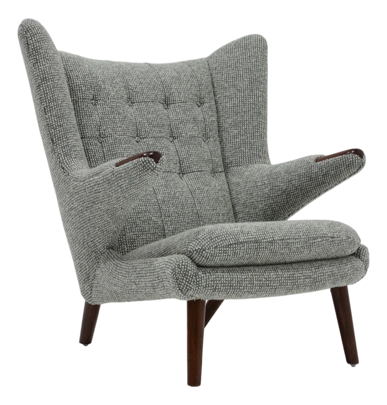 Grey tufted armchair in a stylish interior setting.