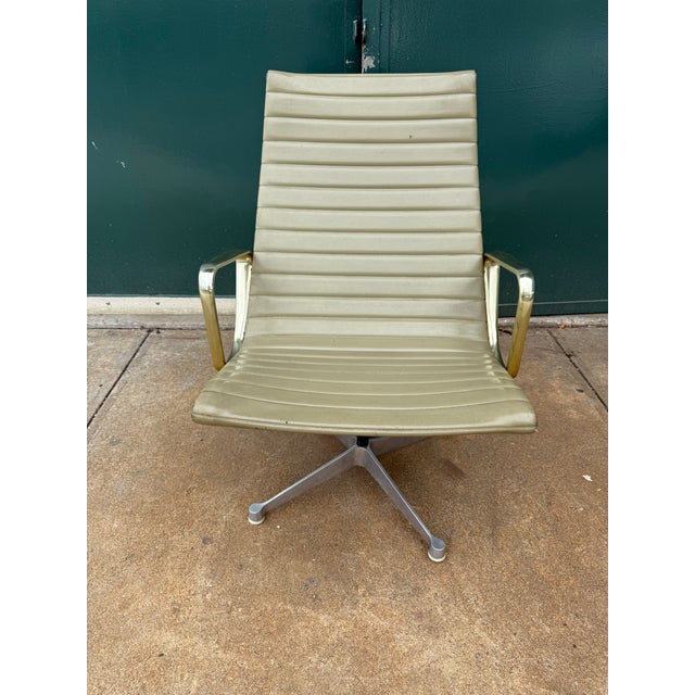 Vintage Herman Miller aluminum frame high back lounge chair with gold/brass tone arms and green vinyl upholstery designed...