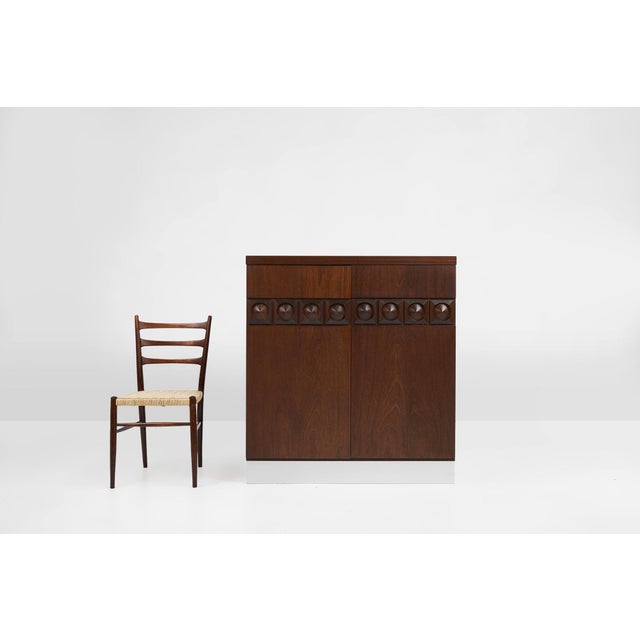 A striking Belgian Brutalist bar cabinet from the 1970s, crafted in richly toned wood with a brushed aluminium base. The...