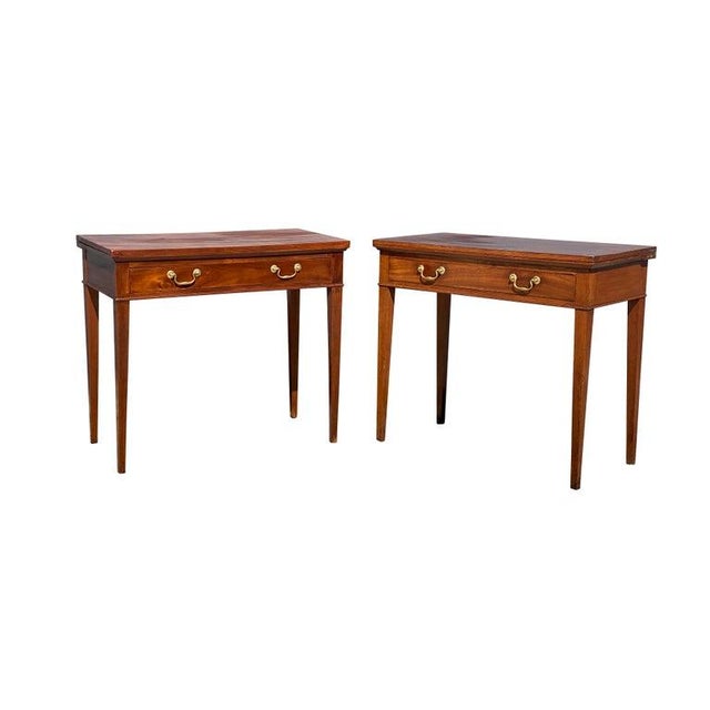 Pair of George III Mahogany Games Tables one of a later date. Each with a rectangular hinged top opening to a playing...