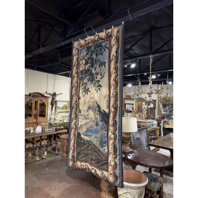 This exceptional antique Aubusson tapestry was handwoven in France circa 1760. The tall vertical panel presents a classic...