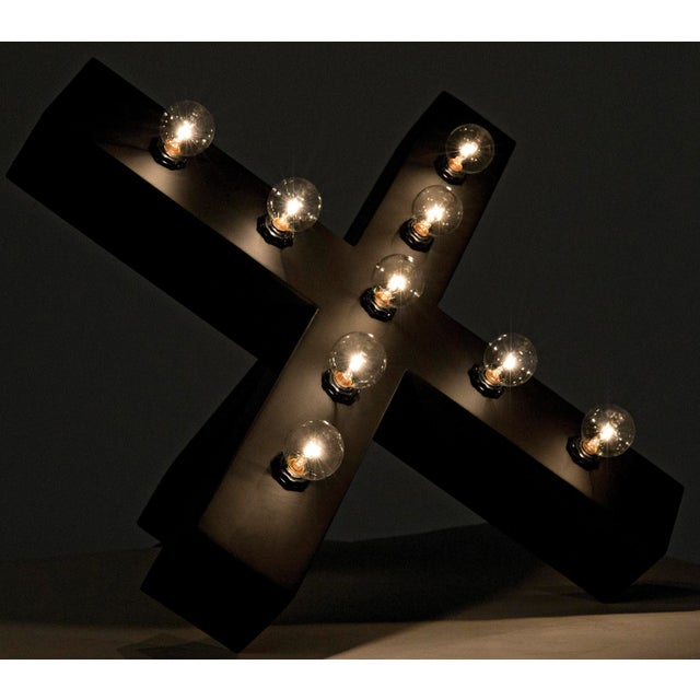 As much a light sculpture as a lamp, the handcrafted Nolen is an ÒXÓ of metal dotted with multiple small bulbs. Each is...