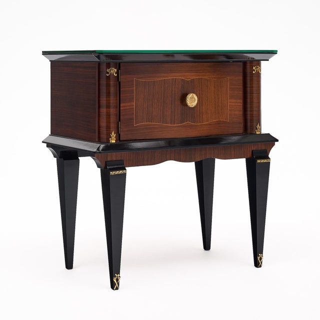 Pair of side tables of Mahogany, finished with a lustrous French polish with ebonized accents. Tapered legs with gilt...