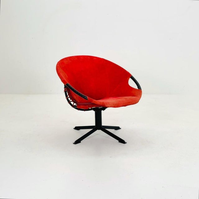 German suede lounge chair, a stunning example of mid-century modern design. Featuring a sleek black iron frame and a...