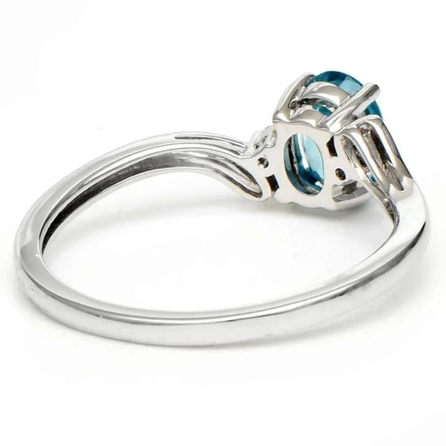Simple and sweet, this 14-karat white gold blue zircon & diamond ring is a true classic. Featuring a center oval blue...