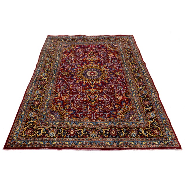 Beautiful vintage Persian Kashan hand-knotted wool rug with a red field. This piece has multicolor accents in a rosette...