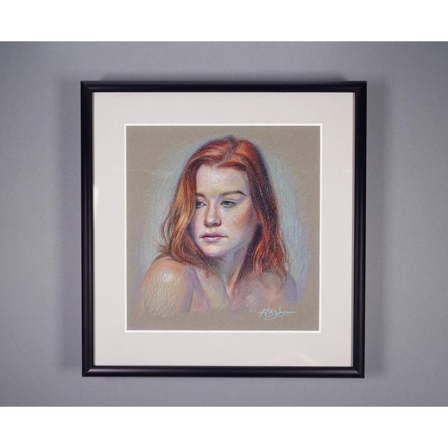 This artwork features a portrait of a young woman, her soft features illuminated against a muted background. The use of...