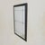 A Louis XVI style wall mirror from the 1960s, framed in carved wood finished in black lacquer. The rectangular frame is...