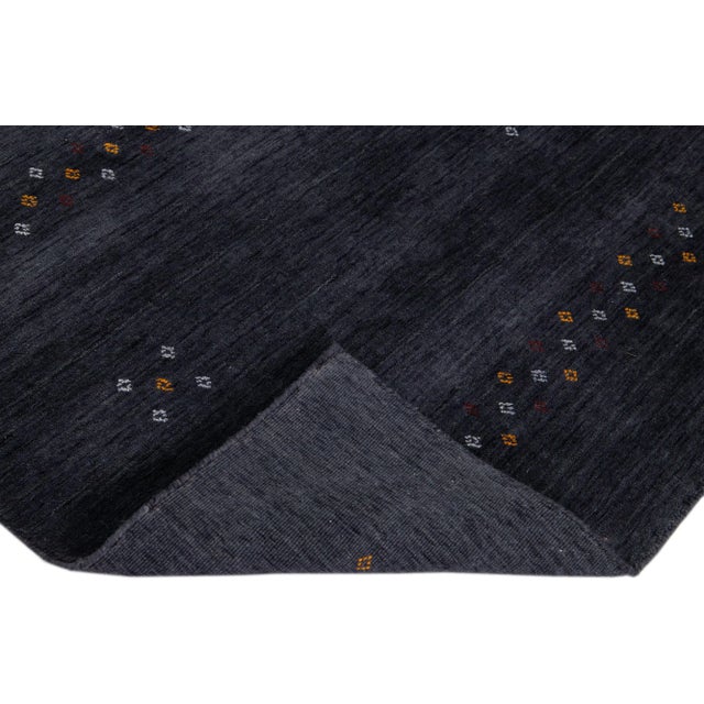 Beautiful modern Gabbeh Style hand-Loom wool rug with a gray- charcoal field with gorgeous minimalist design. This rug...