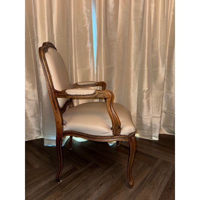 This is a vintage bergère or fauteuil style armchair from Chateau d’Ax Spa (or Chateau d’Ax S.p.A.), an Italian furniture...